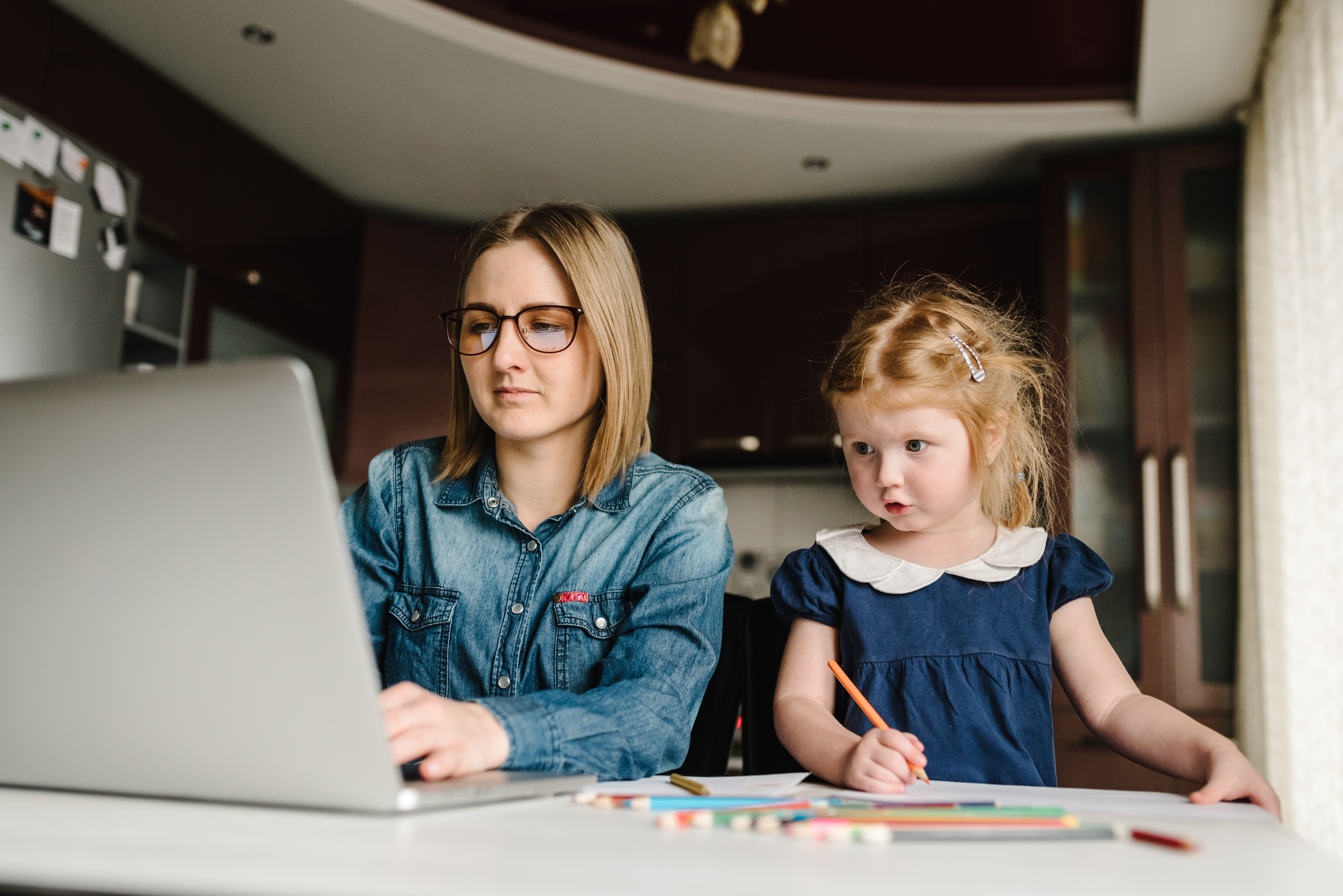 mum-working-at-home-with-daughter-drawing.jpg