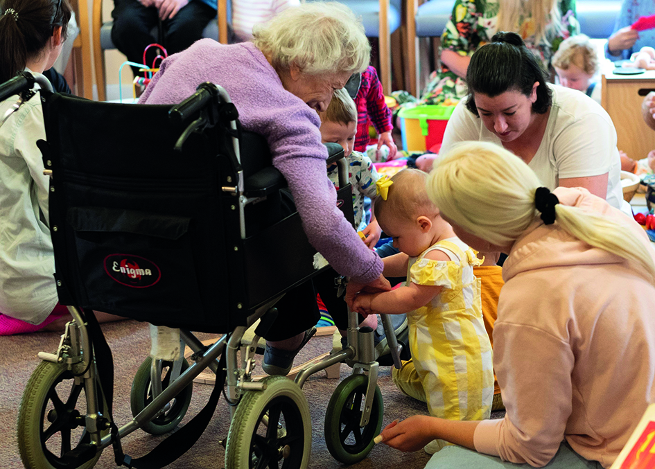 a-holding-onto-m-s-wheelchair-at-baby-and-toddler-group.jpg