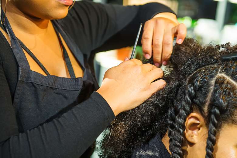According to the Halo Collective, 1 in 5 Black women feel pressure to straighten their hair for work PHOTO Adobe Stock