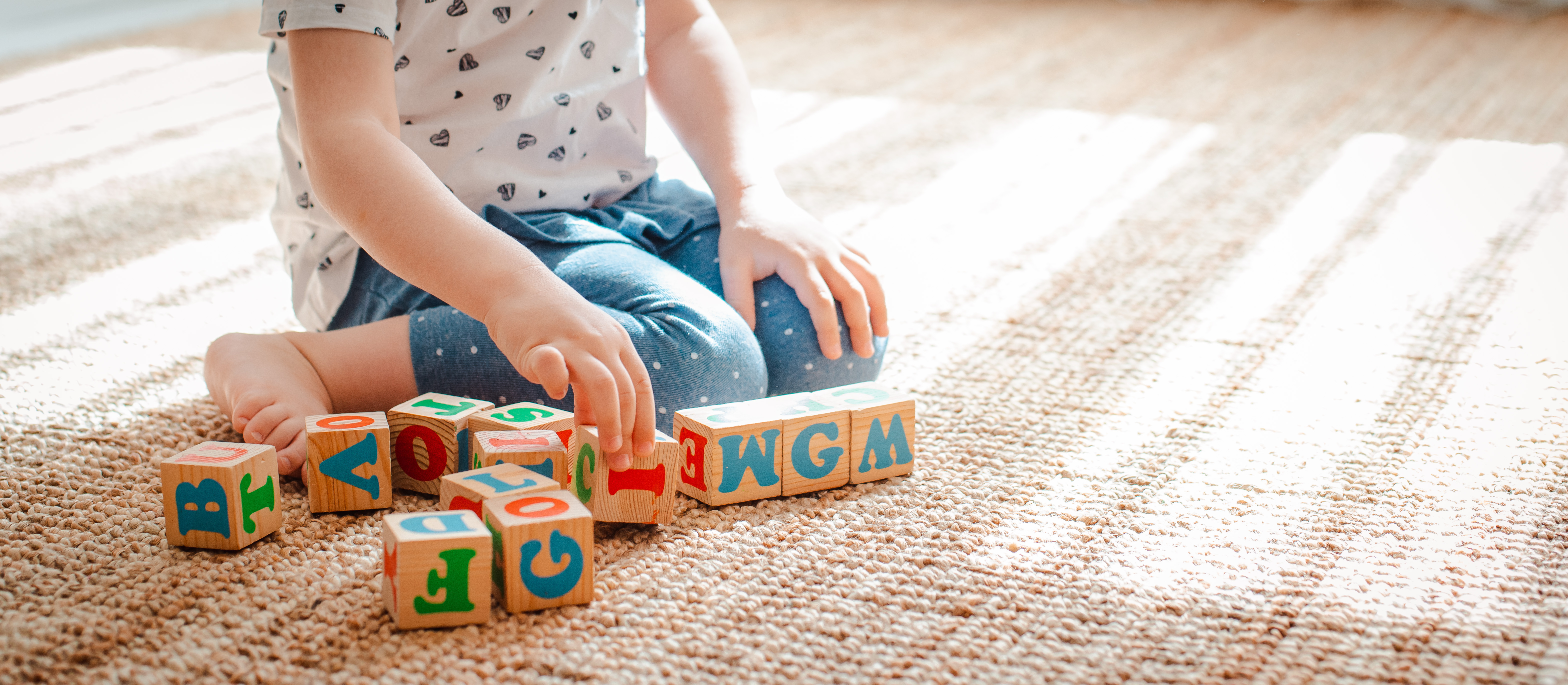 child-with-wodden-letter-blocks.jpeg