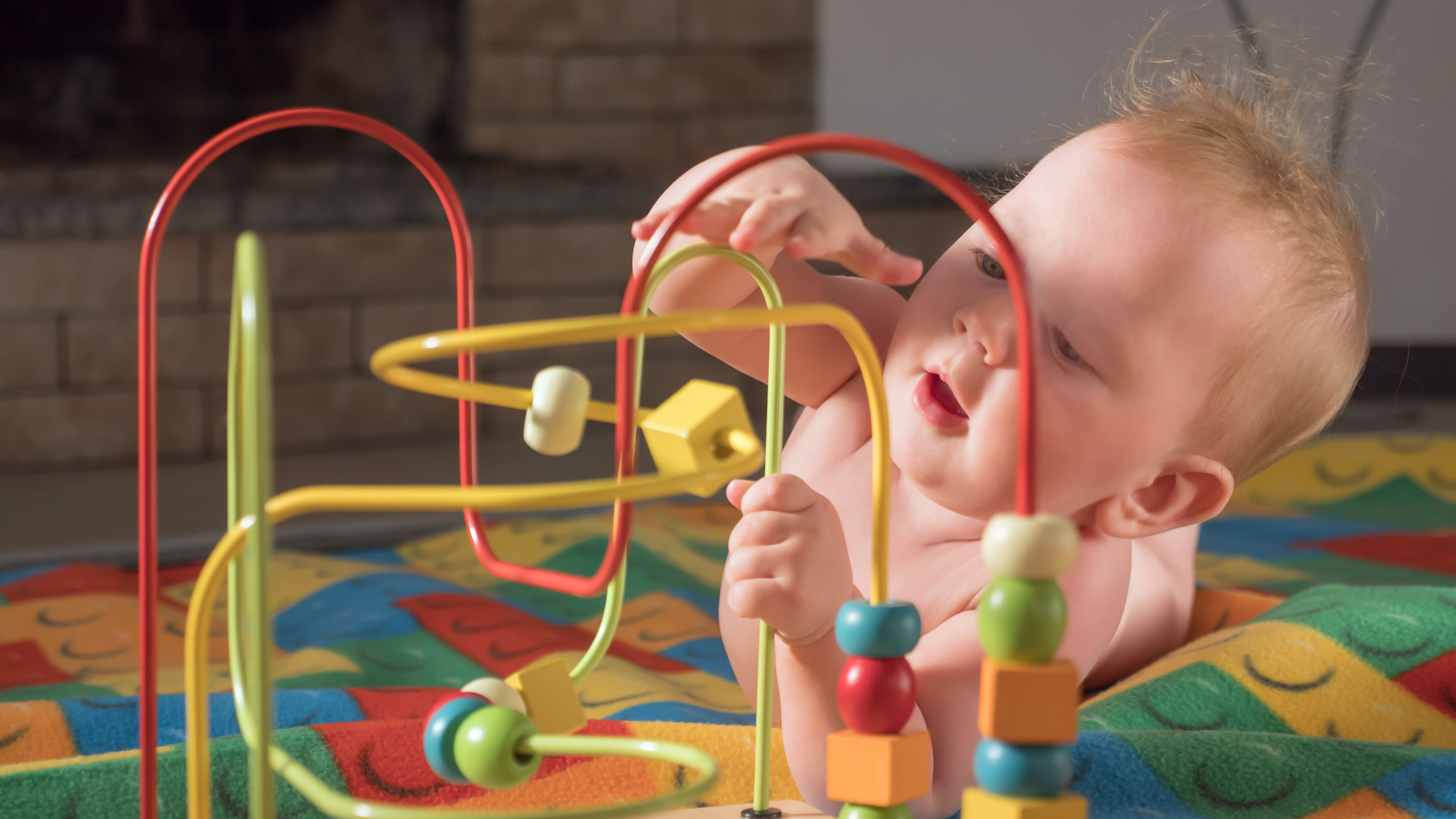 baby-playing-with-wooden-toy.jpeg