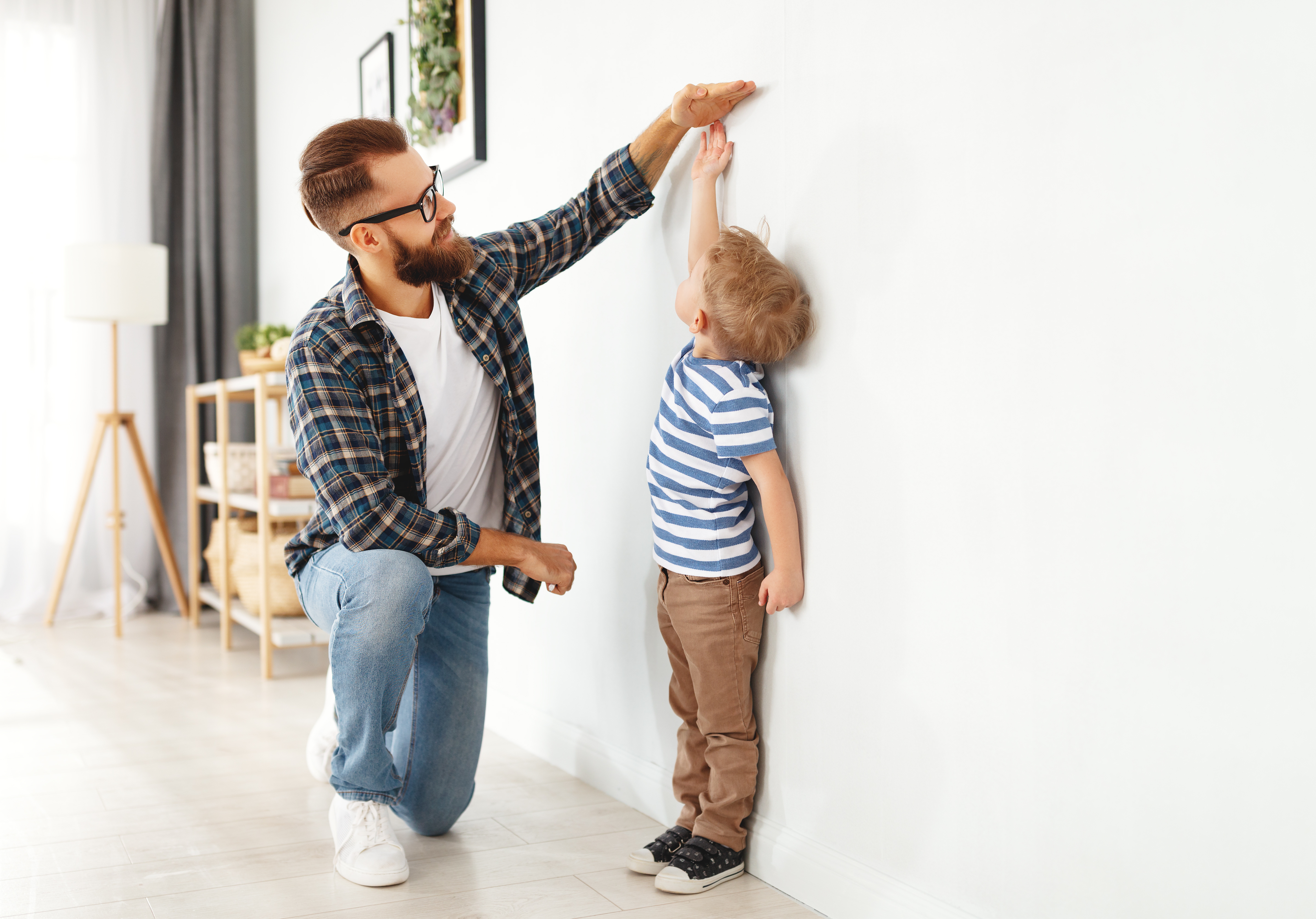 adobestock_343056575_father-and-son-measuring-height.jpeg