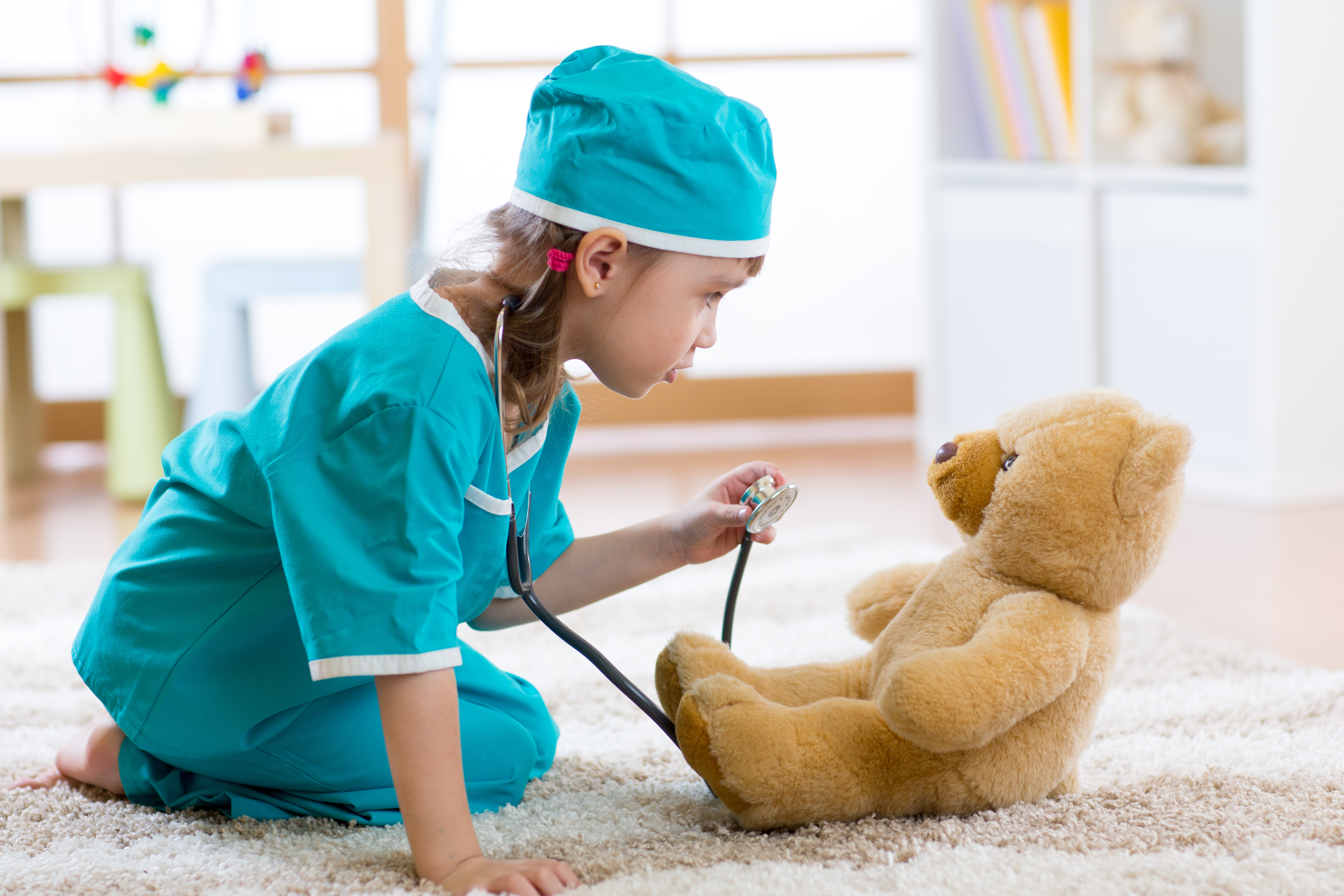 girl-playing-as-a-doctor-with-teddy.jpeg
