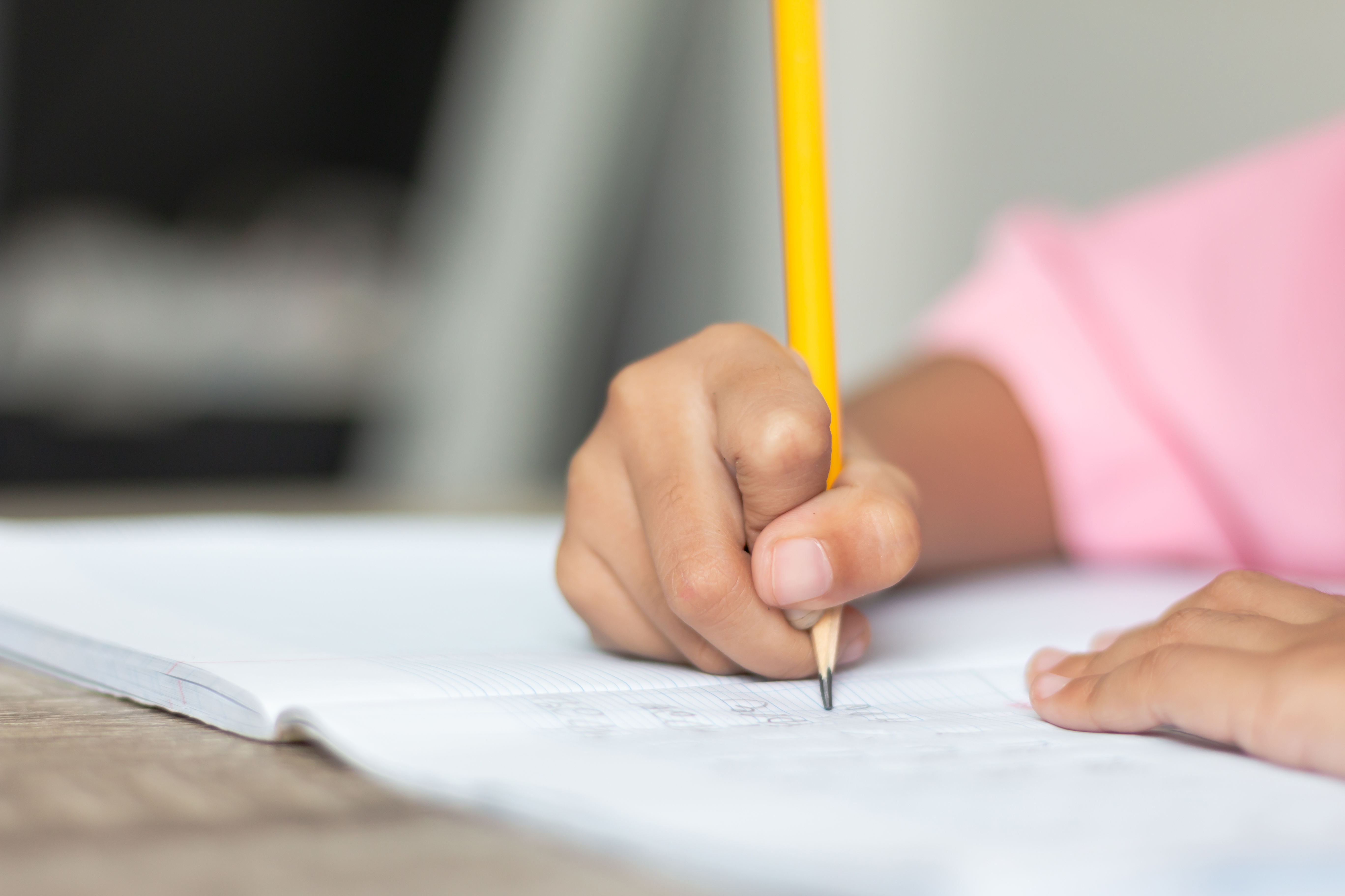 Adobestock 209659534 Child Writing With A Pencil