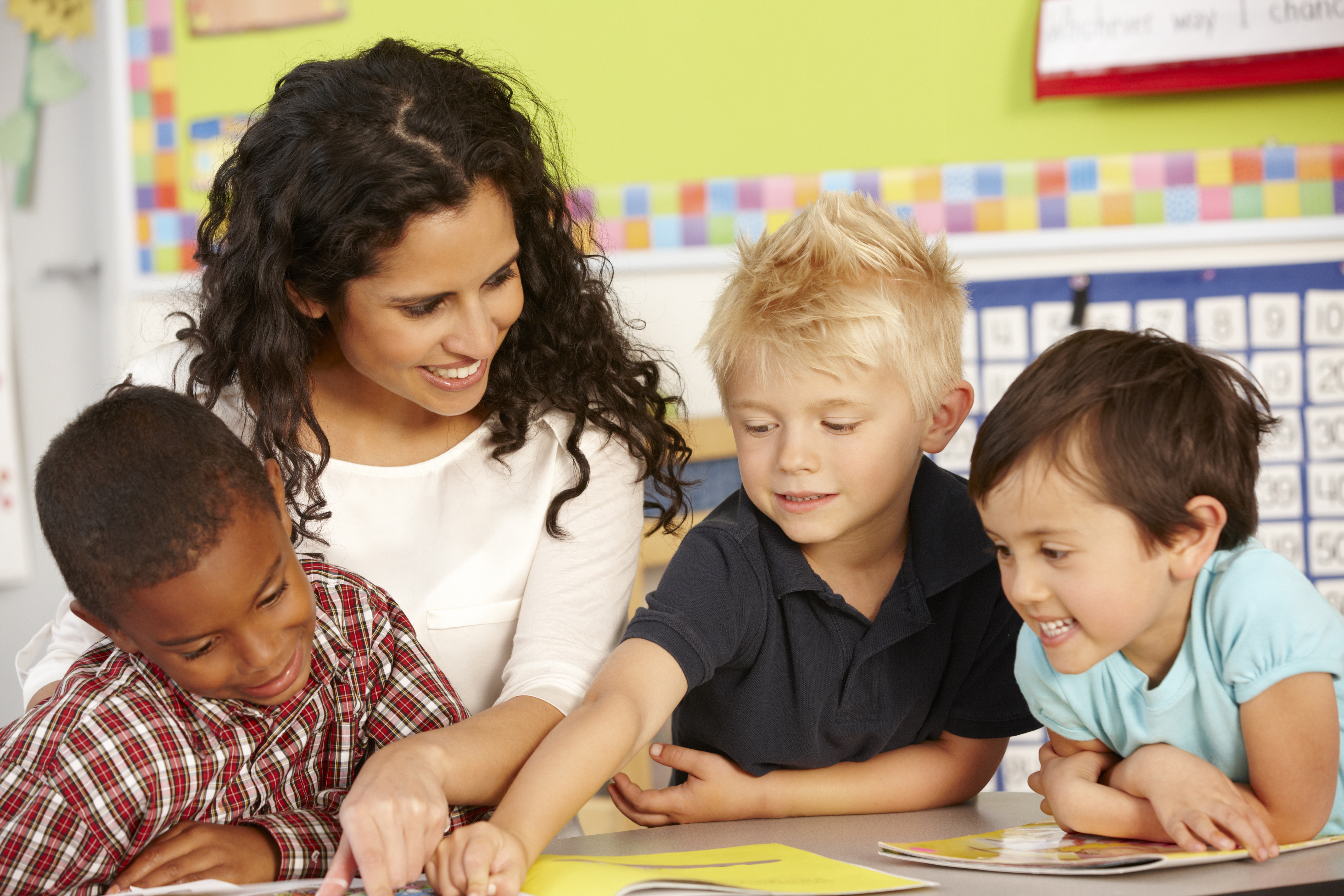 adobestock_84428983_children-reading-picture-book-with-teacher.jpeg