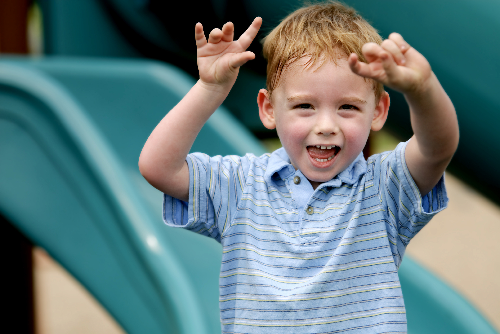 happy-boy-holding-up-hands-playground.jpg