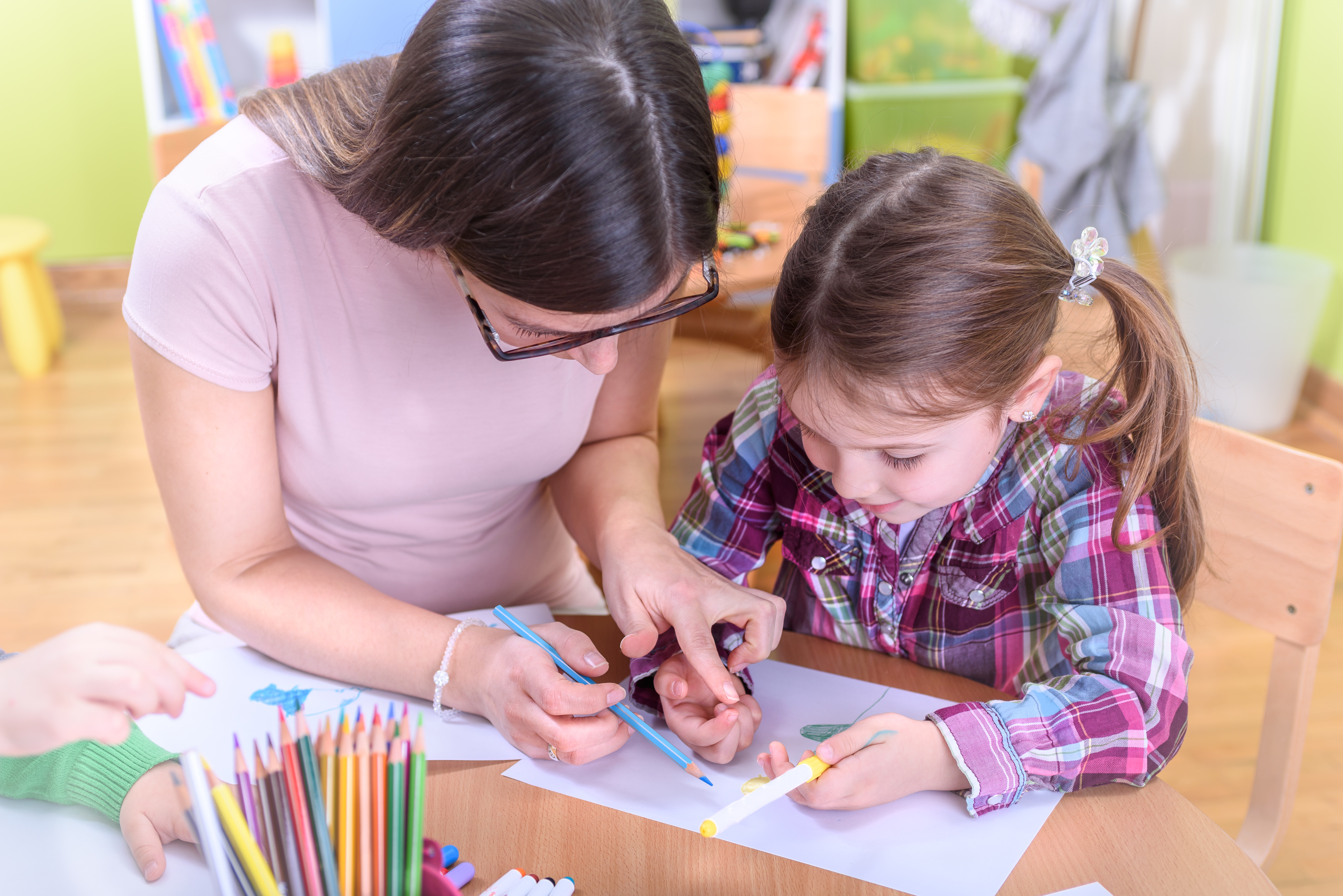 nursery-teacher-drawing-with-child.jpeg