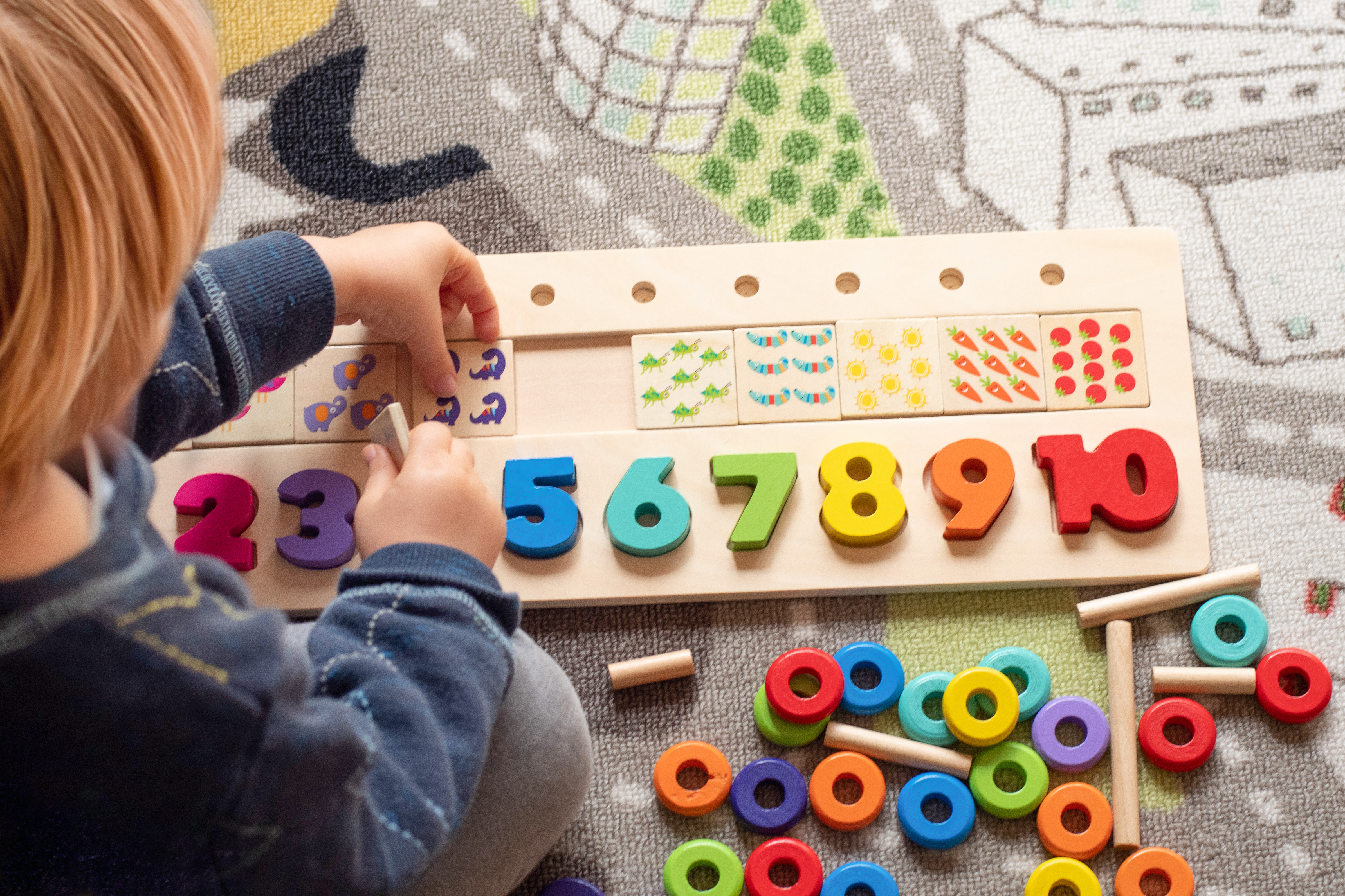 adobestock_476989942_child-playing-with-wooden-numbers.jpeg