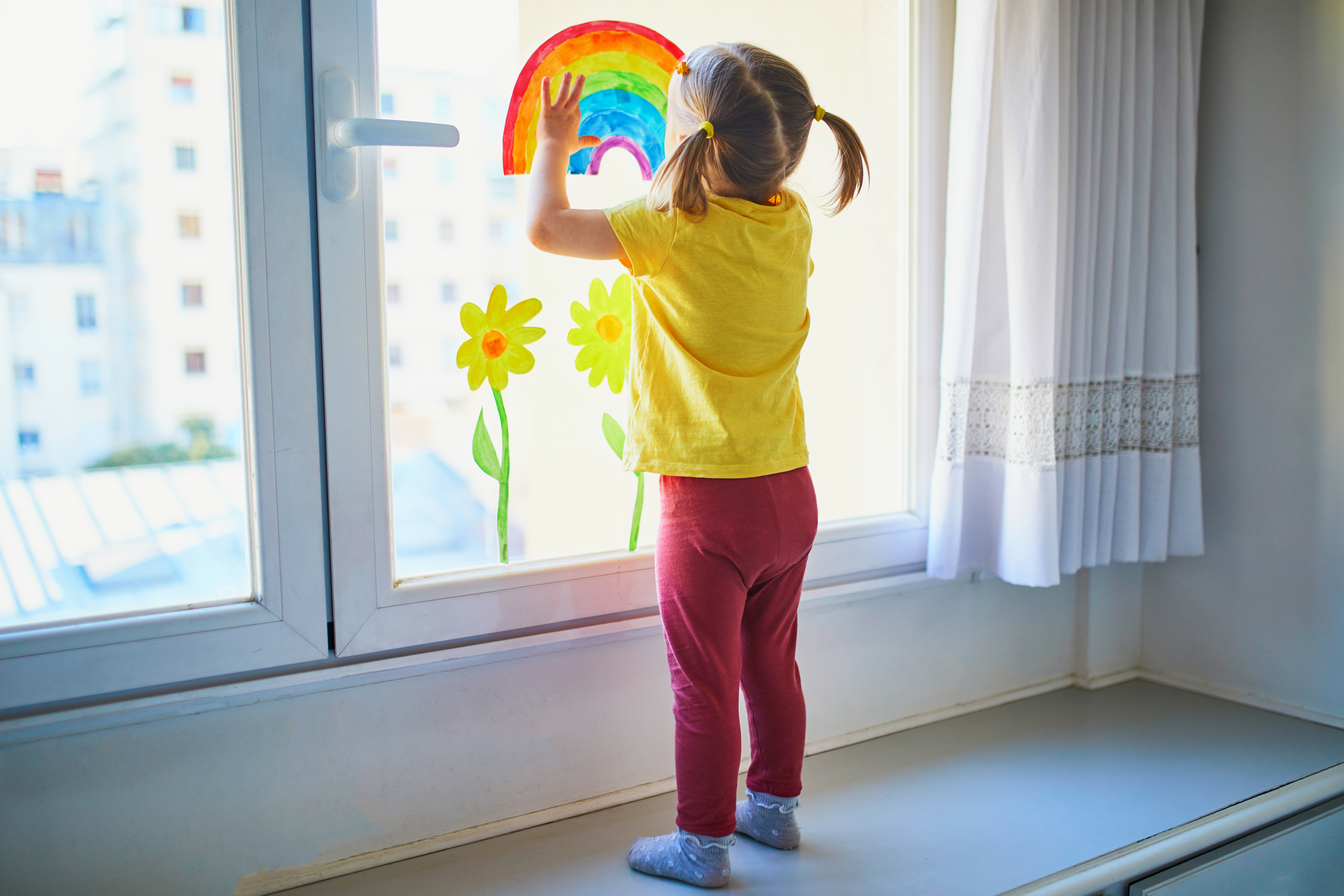 toddler-putting-rainbow-in-window.jpeg