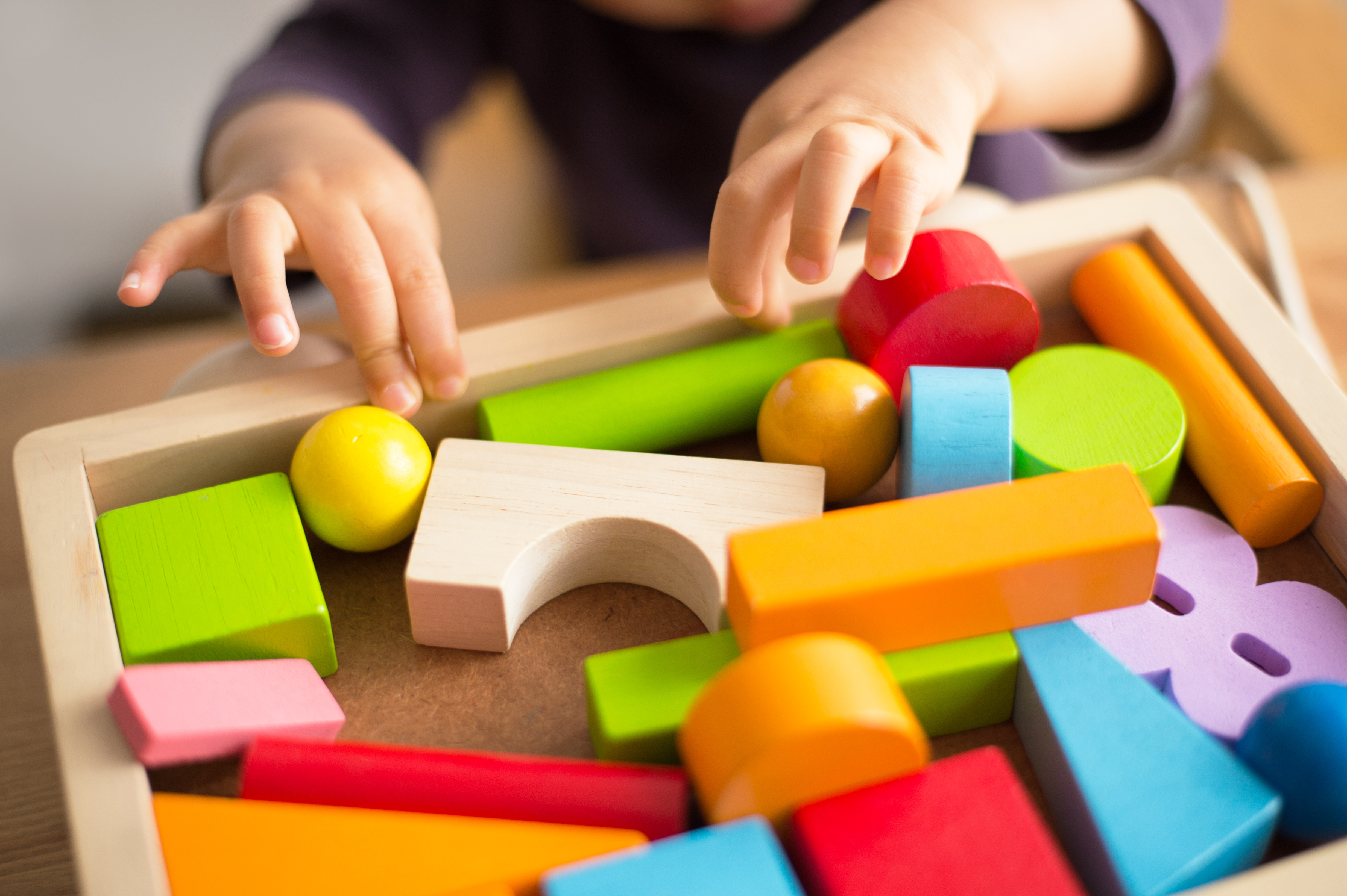 toddler-playing-wooden-blocks.jpeg