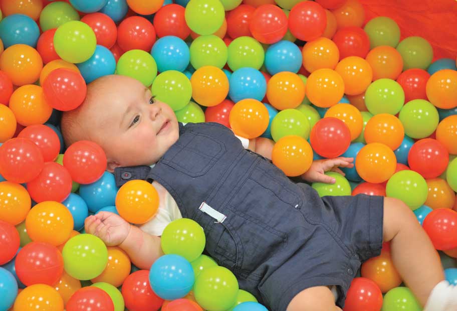 wmsurecare-baby-among-balls.jpg