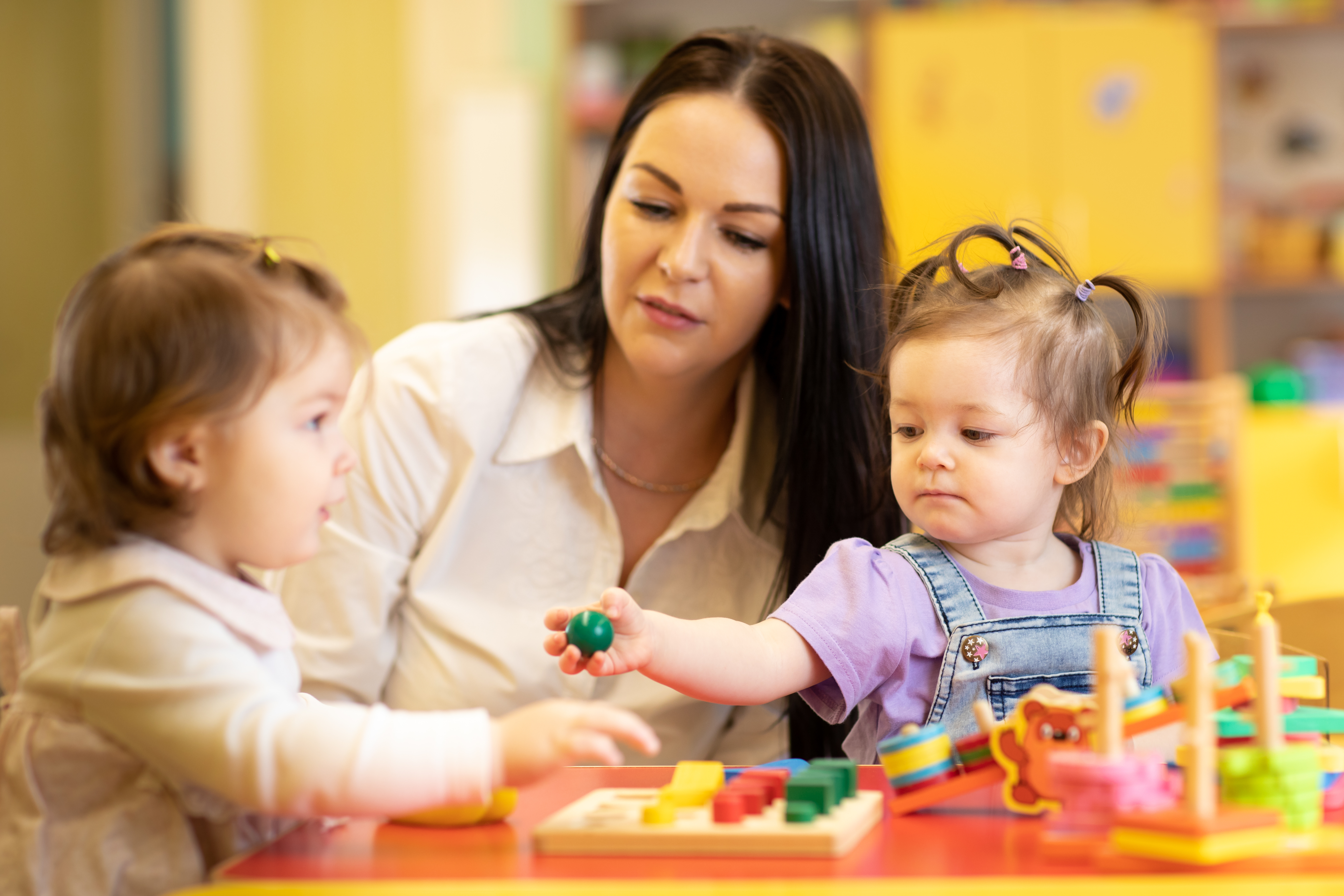 nursery-worker-with-babies.jpeg