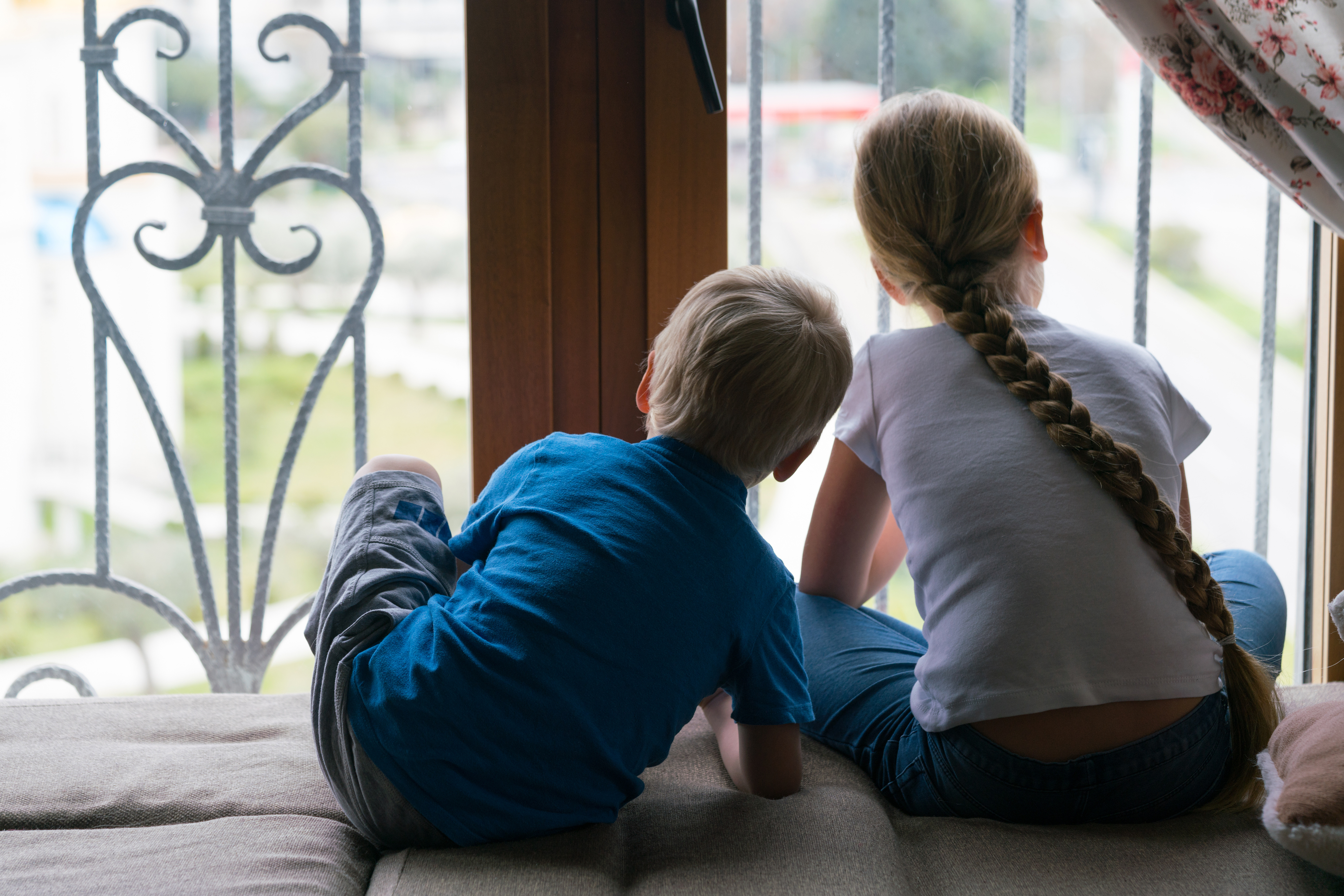 adobestock_334843932_children-looking-out-of-window-self-isolation.jpeg