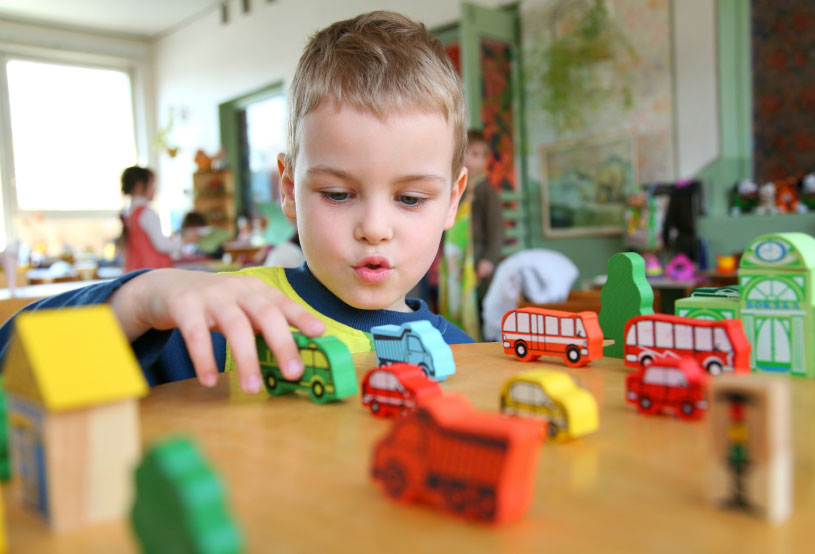 boy-playing-with-wooden-buses.jpg